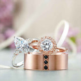 Three-stone engagement ring with pear side stones in 14K gold, diamond center, on hand