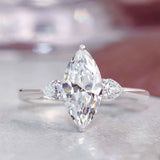 Three-stone engagement ring with pear side stones in 14K gold, diamond center, front view