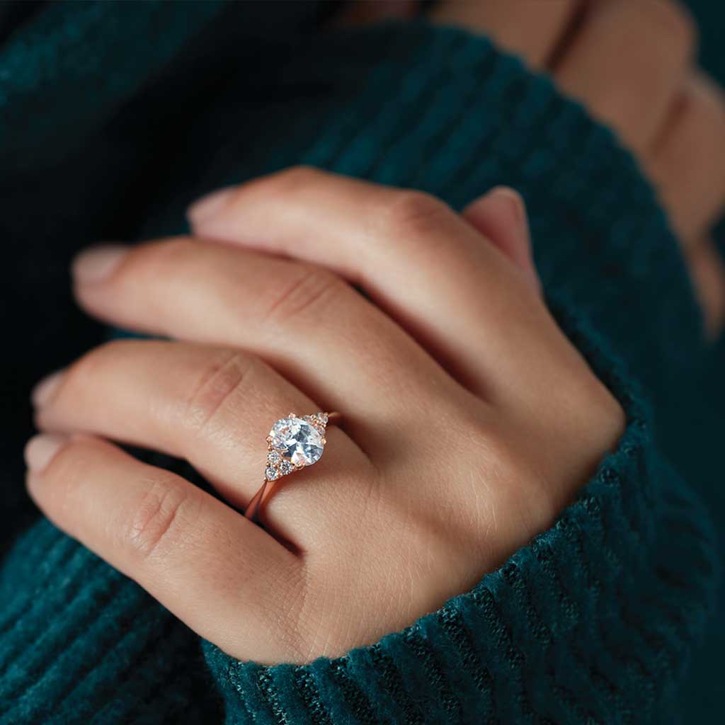 Modern cluster accent engagement ring setting shown on model