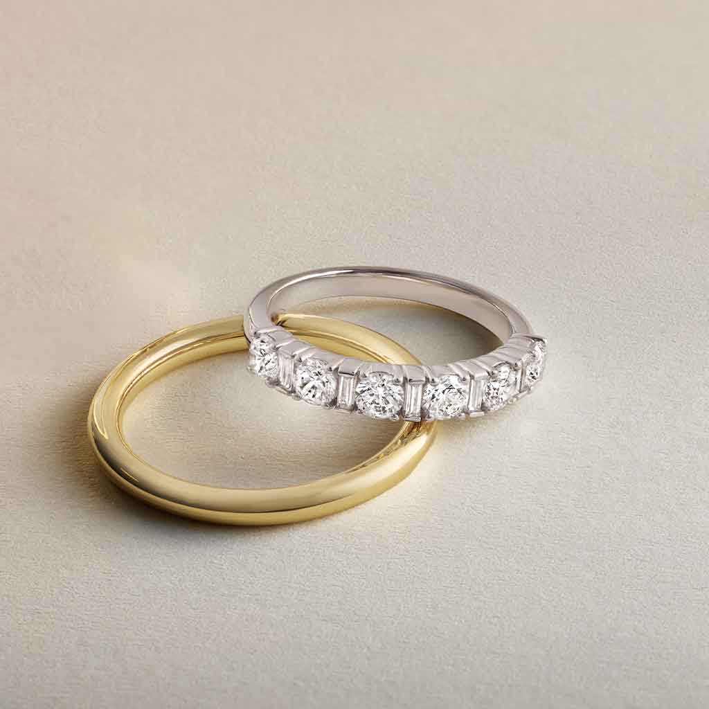 white gold diamond band with round and baguette diamonds styled with gold band