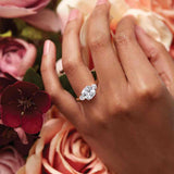 Three-stone engagement ring with round side stones in 14K gold, diamond center, three-quarter angle