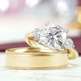 Three-stone engagement ring with round side stones in 14K gold, diamond center, front view