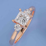 Three-stone engagement ring with round side stones in 14K gold, diamond center, front view