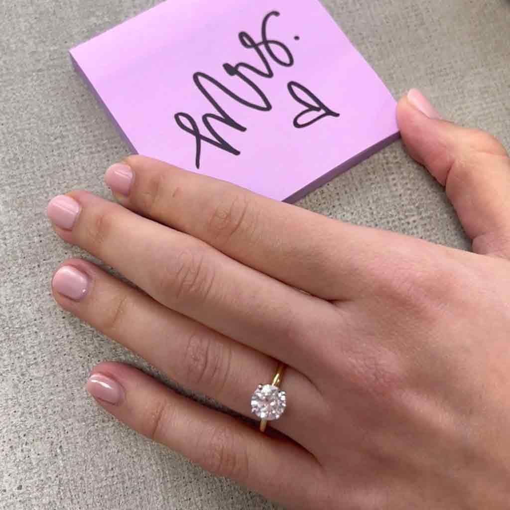Scroll solitaire engagement ring in 14K gold, diamond center, three-quarter angle