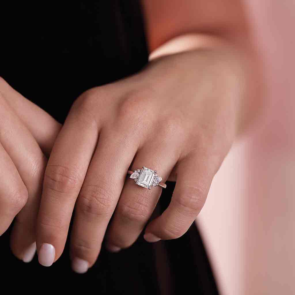 Modern cluster engagement ring setting with side diamonds