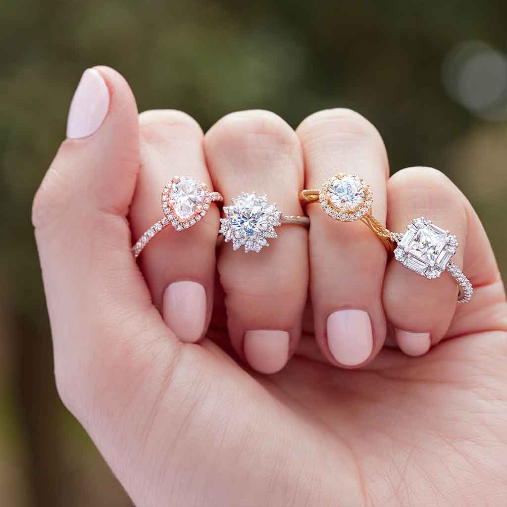 Floral halo engagement ring editorial shot showing round and marquise diamond halo
