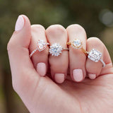 Floral halo engagement ring editorial shot showing round and marquise diamond halo