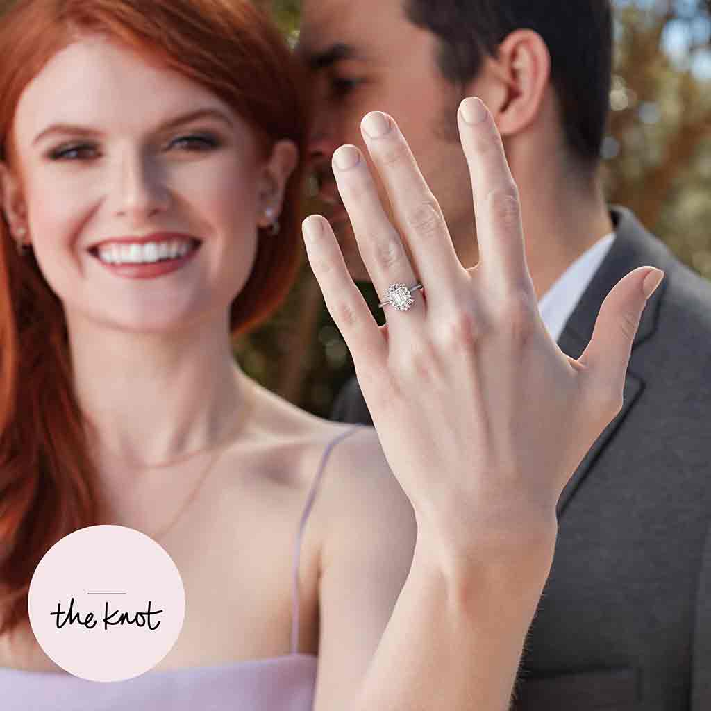 Floral halo engagement ring on model showing scale and sparkle