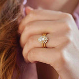 Saddle halo diamond engagement ring setting in 14K gold, diamond center, three-quarter angle