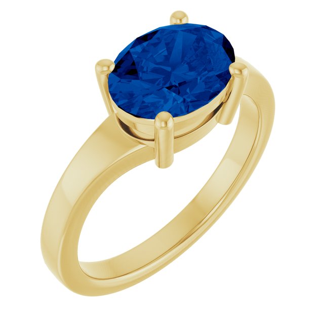 Oval sapphire ring in 14K yellow gold, side profile of bezel setting