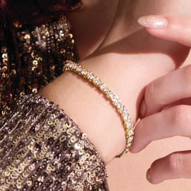 Classic diamond tennis bracelet in 14K yellow gold shown on wrist