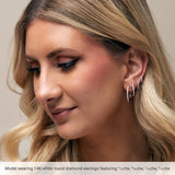 white gold huggy diamond hoops on model
