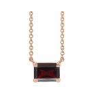 Emerald-cut garnet birthstone necklace set in 14K rose gold with vertical minimalist pendant design
