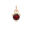 Ethically sourced garnet charm set in minimalist prong gold setting