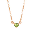 Tiny birthstone pendant in 14K rose gold with a faceted peridot center for subtle sparkle.