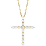 close up of diamond cross pendant in 14k yellow gold