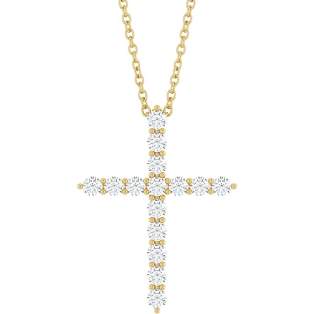 close up of diamond cross pendant in 14k yellow gold