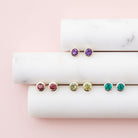 Bezel-set birthstone studs in yellow gold for birthday gifts