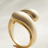 Puff bypass ring in 14K yellow gold, front view showing sculptural form