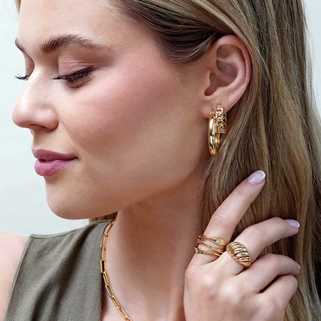 Gold wave ring on model, styled close-up showing width