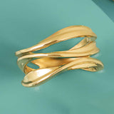 Gold wave ring in 14K yellow gold, sculptural front product view