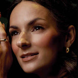 Gold huggy hoop earrings on model, second angle