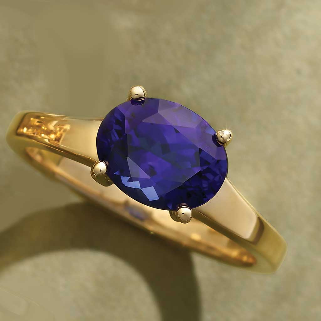 Oval sapphire cocktail ring in 14K gold, front view of 2.5 carat blue gemstone