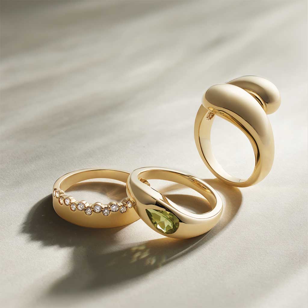 Peridot teardrop ring, editorial styling on surface