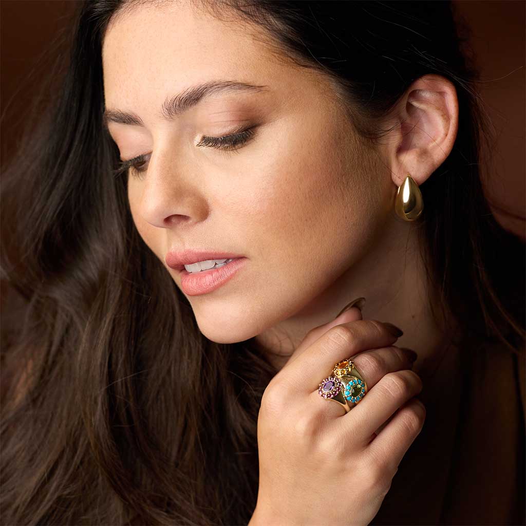 Gemmy cocktail ring with turquoise cabochons in 14K gold, on model