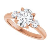 Three-stone engagement ring with round side stones in 14K gold, diamond center, showing setting detail variant--Oval variant--1CT variant--14K-rose-gold