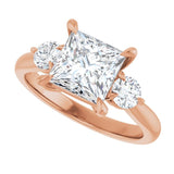 Three-stone engagement ring with round side stones in 14K gold, diamond center, close-up of round side stones variant--Square variant--2CT variant--14K-rose-gold
