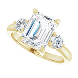 Three-stone engagement ring with round side stones in 14K gold, diamond center, three-quarter angle variant--Emerald variant--3CT variant--14K-yellow-gold
