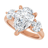 Three-stone engagement ring with round side stones in 14K gold, diamond center, showing setting detail variant--Pear variant--3CT variant--14K-rose-gold