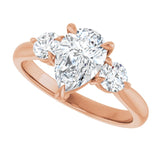 Three-stone engagement ring with round side stones in 14K gold, diamond center, three-quarter angle variant--Pear variant--2CT variant--14K-rose-gold