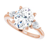 Three-stone engagement ring with pear side stones in 14K gold, diamond center, three-quarter angle variant--Oval variant--3CT variant--14K-rose-gold