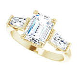 Three-stone baguette side stone ring in 14K gold, diamond center, on hand/2-CT.5CT variant--Emerald variant--1.5CT variant--14K-yellow-gold