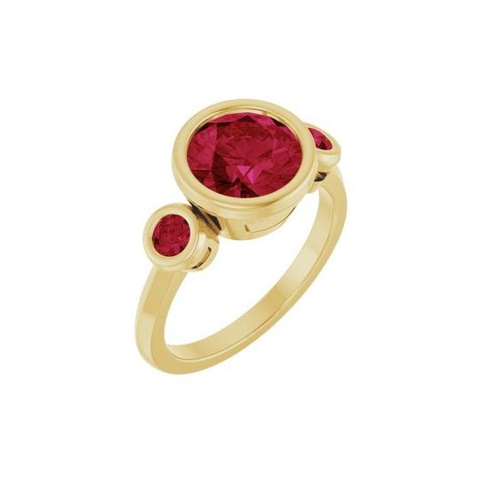 Lab-grown ruby cocktail ring with recycled gold, designed in a three-stone setting