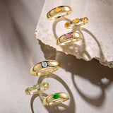 Yellow gold diamond dome ring styled with other rings