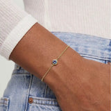 Model wearing bezel-set alexandrite bracelet. variant--14K-yellow-gold variant--Alexandrite
