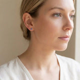 Alexandrite birthstone stud earrings on model, color-shift studs at ear