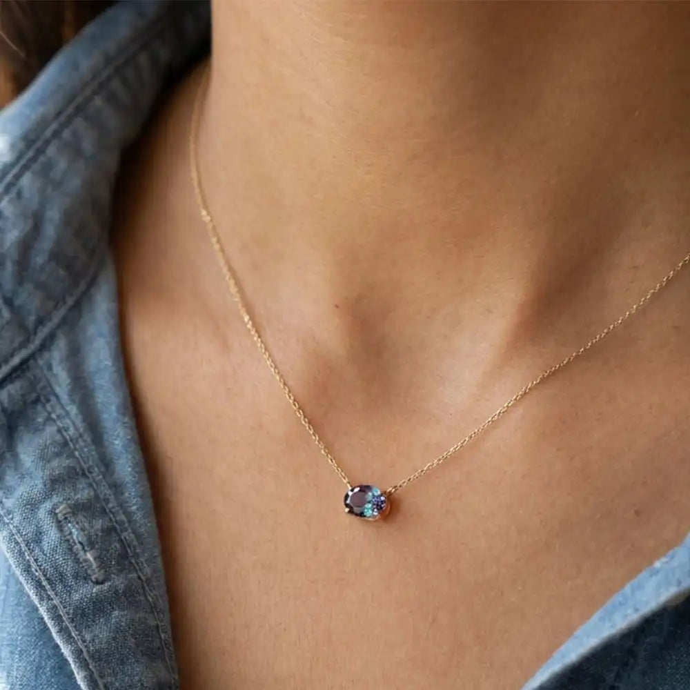 Oval alexandrite prong-set necklace on fine gold chain on model variant--14K-rose-gold variant--14K-white-gold variant--14K-yellow-gold variant--Sterling-silver variant--Alexandrite