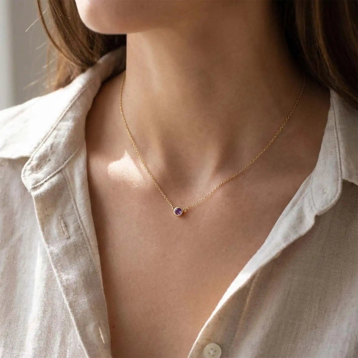 Bezel-set amethyst necklace on model, layered at the collarbone