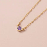 Bezel-set amethyst birthstone necklace in 14K yellow gold on cable chain