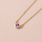 Bezel-set amethyst birthstone necklace in 14K yellow gold on cable chain