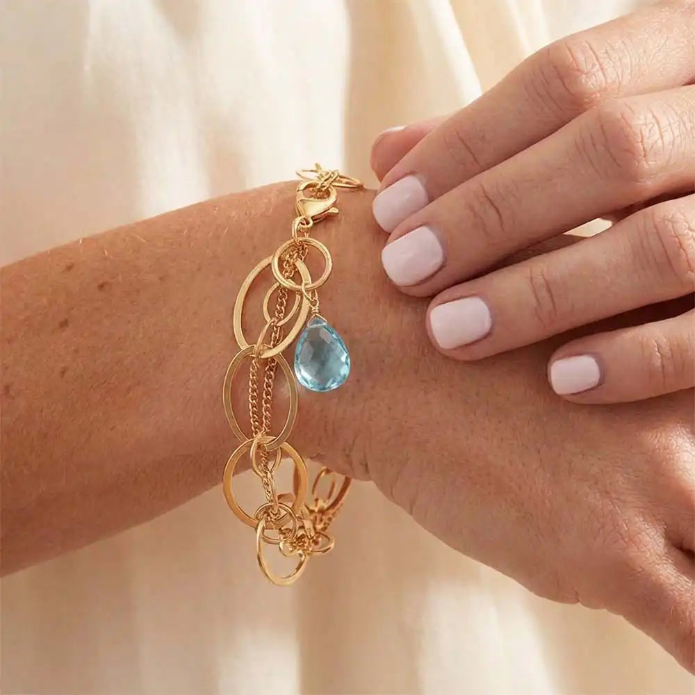 Natural aquamarine woven chain bracelet in sterling silver, close-up of setting in gold-fill variant--Gold-fill variant--Sterling-silver variant--Oxidized-sterling-silver variant--Aquamarine