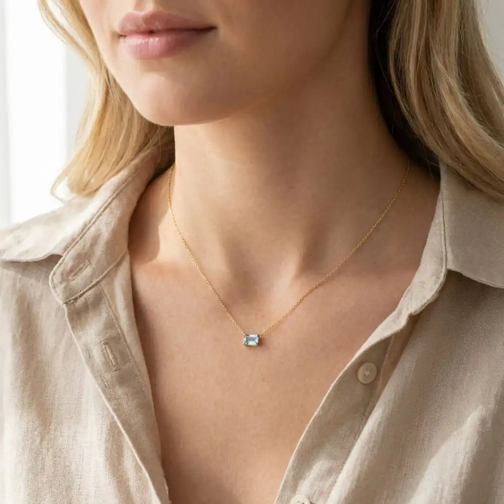 Minimalist aquamarine necklace featuring a 5x3mm emerald shown on model variant-14K-yellow-gold variant-14K-white-gold variant-14K-rose-gold variant-Sterling-silver