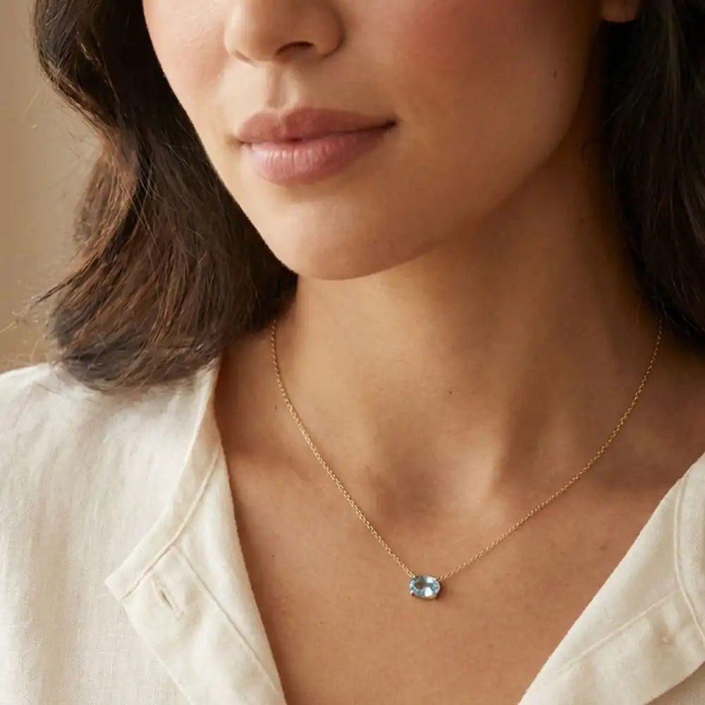 Aquamarine prong-set necklace on fine gold chain on model variant--14K-rose-gold variant--14K-white-gold variant--14K-yellow-gold variant--Sterling-silver variant--Aquamarine