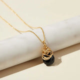 Natural black sapphire pendant necklace in sterling silver, styled on chain necklace