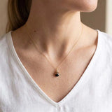 Natural black sapphire pendant necklace in sterling silver, close-up of setting in gold-fill