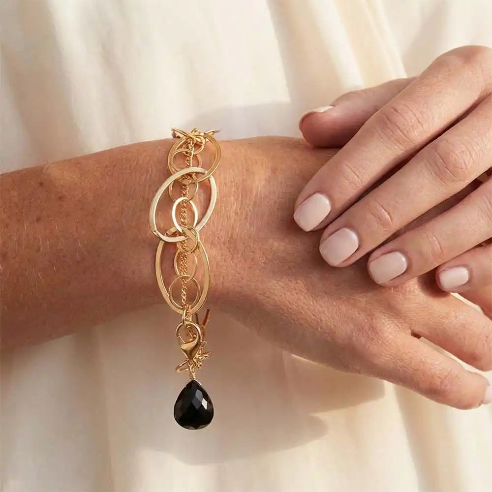Natural black sapphire woven chain bracelet in sterling silver, close-up of setting in gold-fill